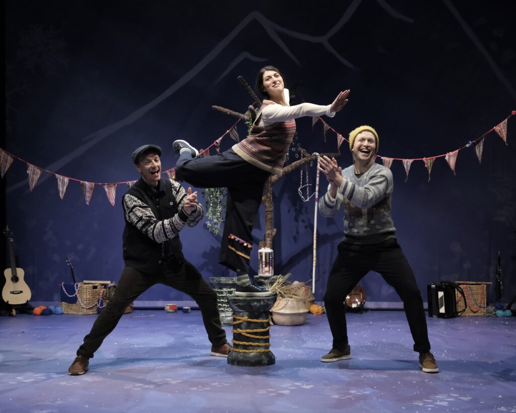 Image of 3 performers on stage in costume